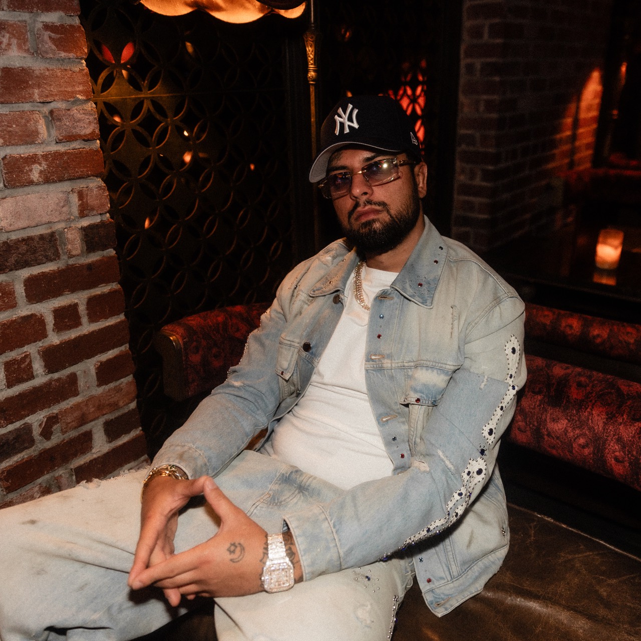 David Chaboki (Shibo) seated in crystal denim and a Yankees cap at TAO, DDNYC 2026
